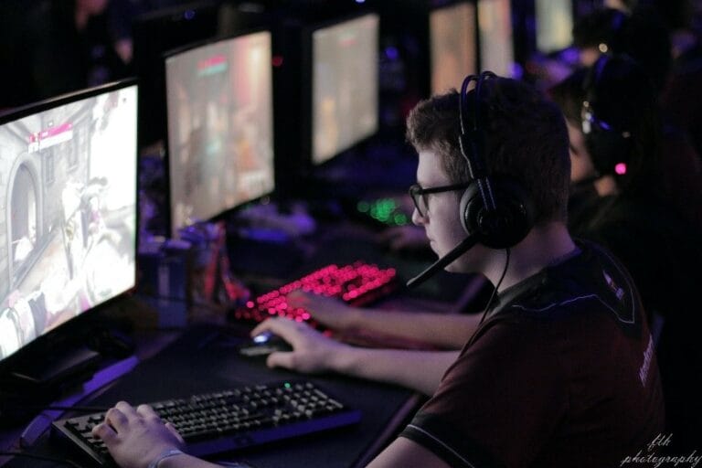A gamer using an Esport AV setup at a computer monitor